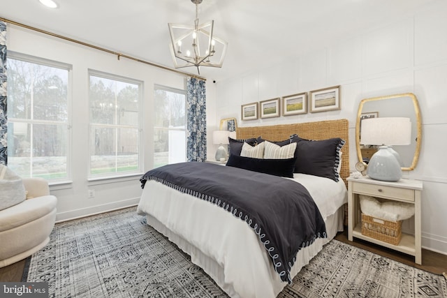 bedroom featuring a chandelier and wood-type flooring