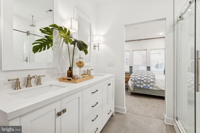 bathroom featuring a shower with door and vanity