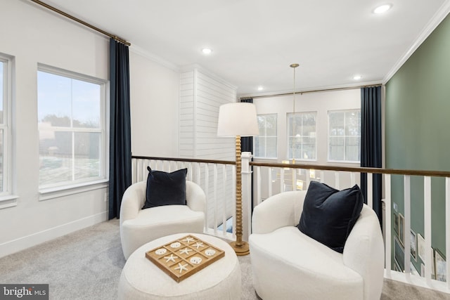 living area featuring ornamental molding and light colored carpet