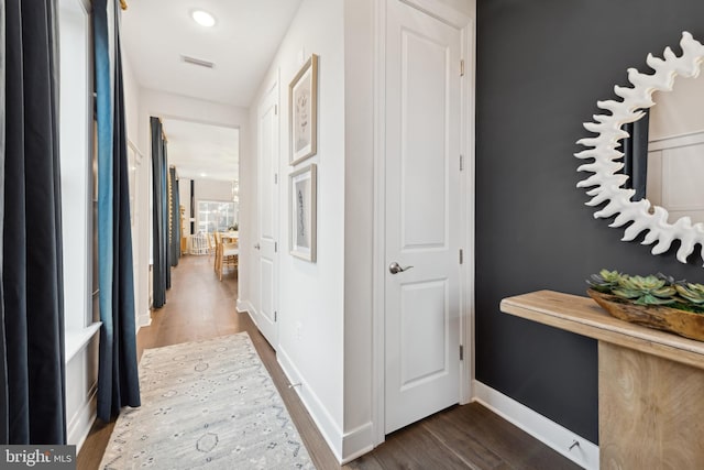 corridor featuring dark hardwood / wood-style floors