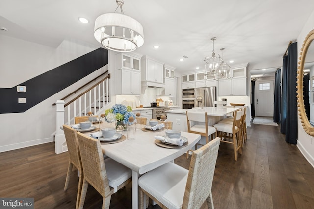 dining room with a notable chandelier and dark hardwood / wood-style flooring