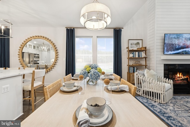 dining area with a notable chandelier and dark hardwood / wood-style flooring