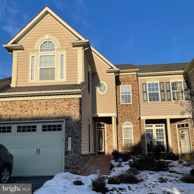 view of front of house with a garage and stone siding