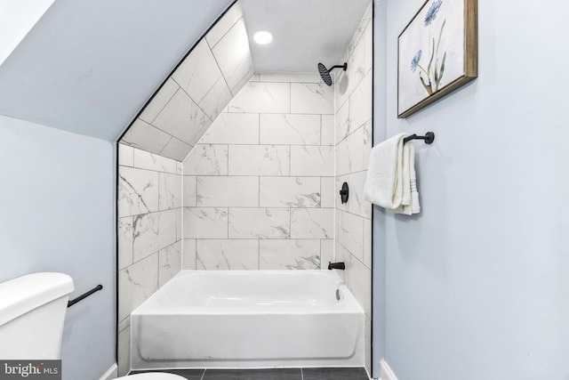 bathroom with toilet and tiled shower / bath combo