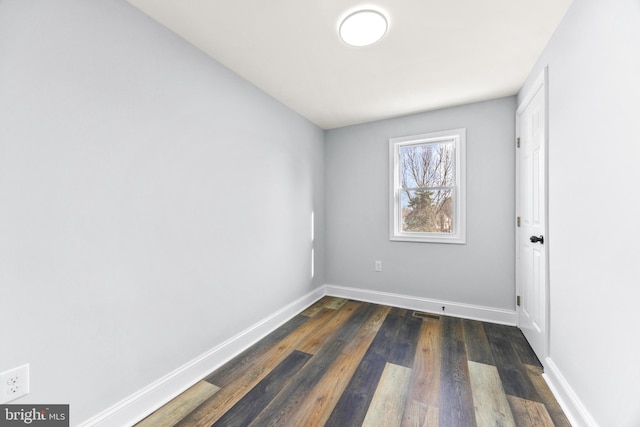 empty room featuring dark hardwood / wood-style flooring