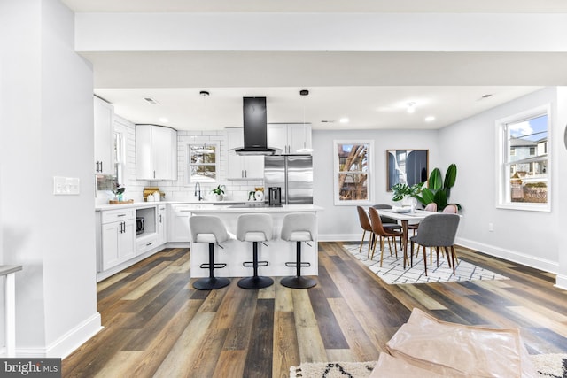 kitchen with white cabinetry, a center island, stainless steel fridge with ice dispenser, and extractor fan