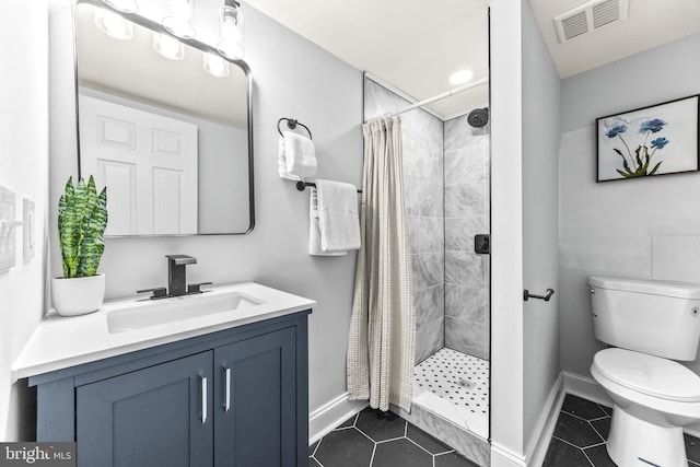 bathroom featuring a shower with curtain, vanity, toilet, and tile patterned flooring