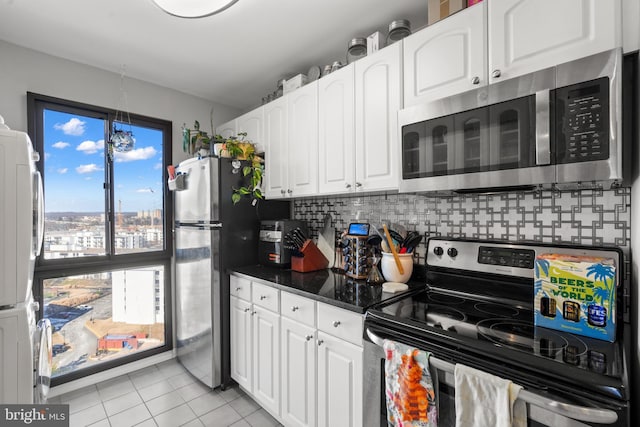 kitchen featuring backsplash, appliances with stainless steel finishes, and white cabinets