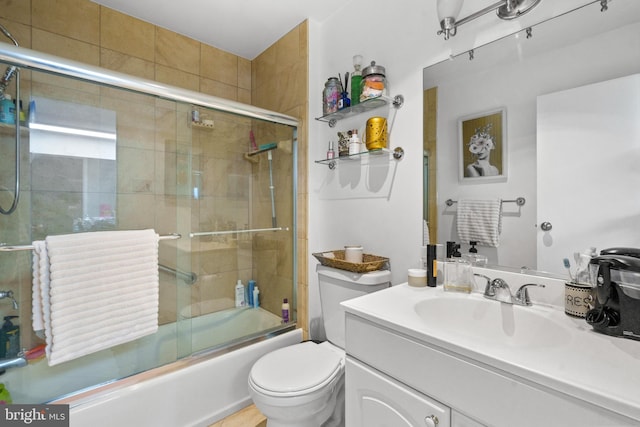 full bathroom with vanity, combined bath / shower with glass door, and toilet