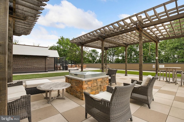 view of patio with a pergola, an outdoor hangout area, and exterior kitchen