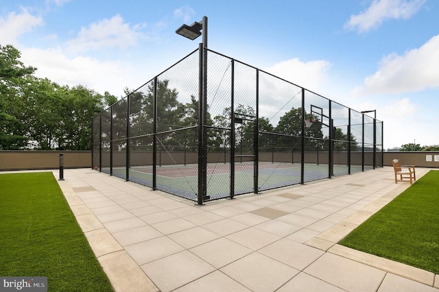 view of basketball court with a lawn