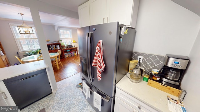 kitchen featuring crown molding, dishwasher, hanging light fixtures, white cabinets, and stainless steel fridge with ice dispenser