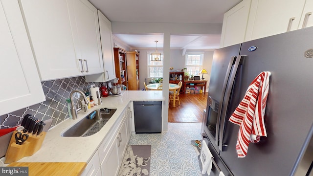 kitchen with sink, stainless steel fridge with ice dispenser, and white cabinets