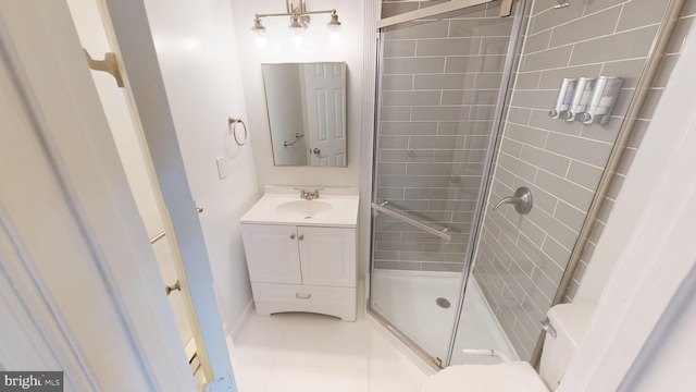 bathroom with vanity, toilet, an enclosed shower, and tile patterned flooring