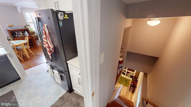 kitchen featuring white cabinetry, stainless steel fridge, and light hardwood / wood-style flooring