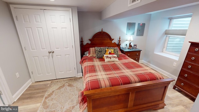 bedroom with light hardwood / wood-style flooring and a closet