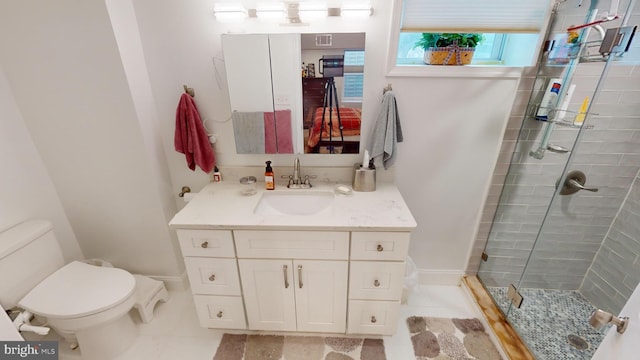 bathroom with vanity, a shower with shower door, and toilet