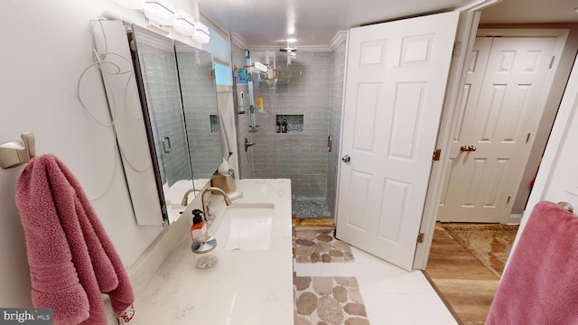 bathroom with vanity, an enclosed shower, and hardwood / wood-style floors