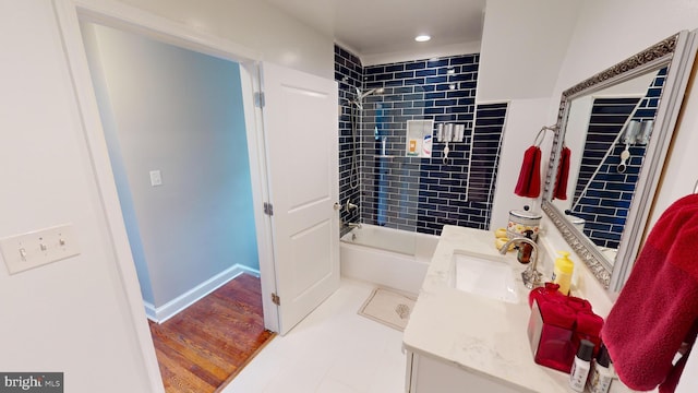 bathroom with vanity, tiled shower / bath combo, and hardwood / wood-style flooring