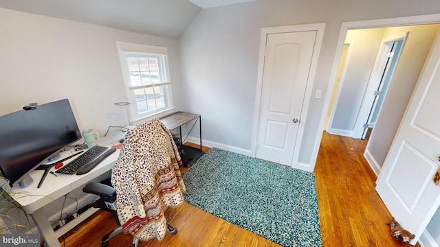 office area featuring vaulted ceiling and hardwood / wood-style floors