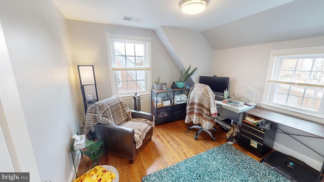 office space featuring vaulted ceiling and light hardwood / wood-style floors