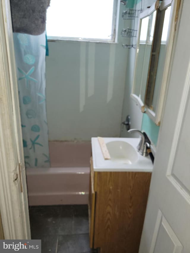 bathroom featuring vanity and shower / tub combo with curtain