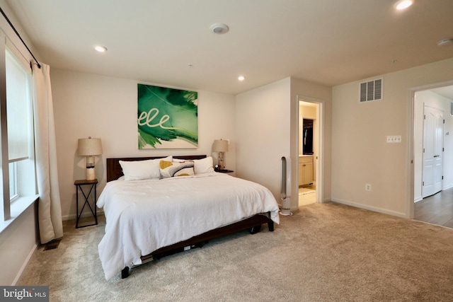 carpeted bedroom with baseboards, ensuite bathroom, visible vents, and recessed lighting