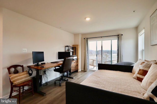 bedroom with access to outside, wood finished floors, and baseboards