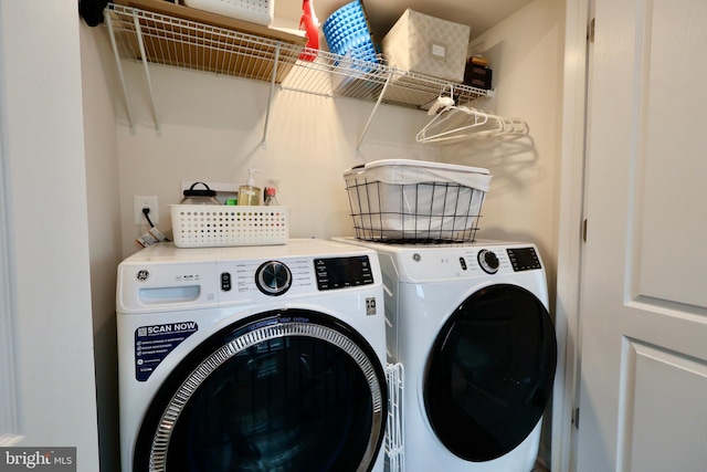 clothes washing area with laundry area and washing machine and clothes dryer