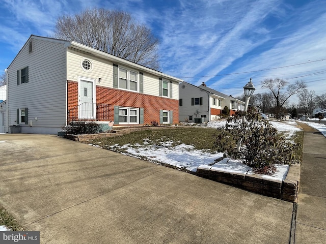 view of front of home featuring brick siding