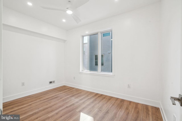 spare room with ceiling fan and light hardwood / wood-style flooring