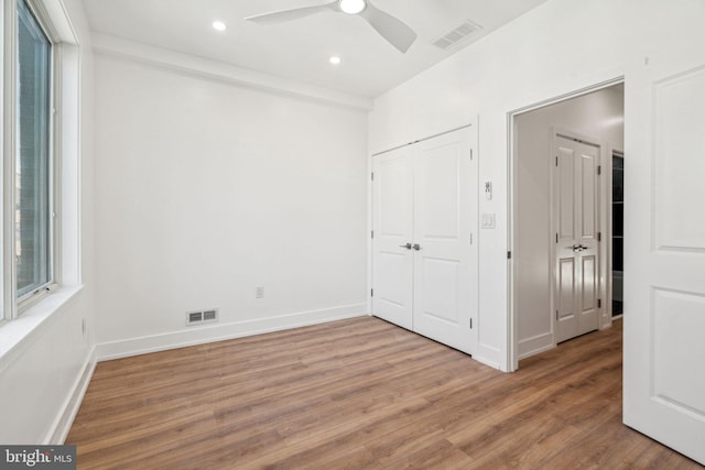 unfurnished bedroom featuring ceiling fan and wood-type flooring