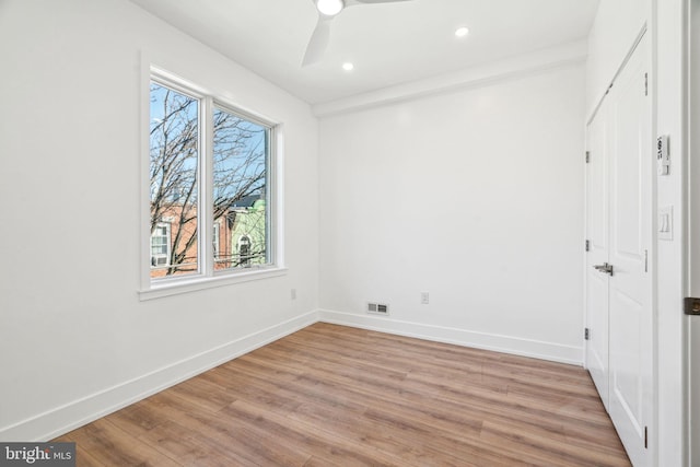 interior space with multiple windows, light wood-type flooring, and ceiling fan