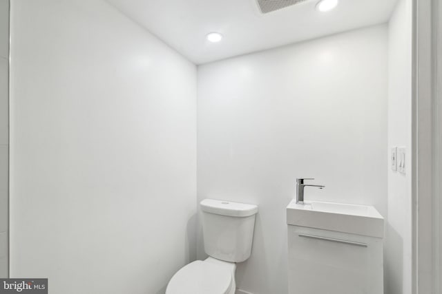 bathroom featuring toilet and vanity