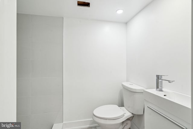 bathroom with toilet and vanity