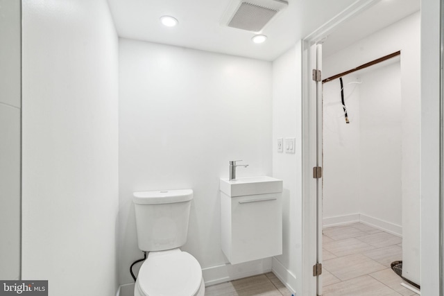 bathroom featuring toilet and vanity