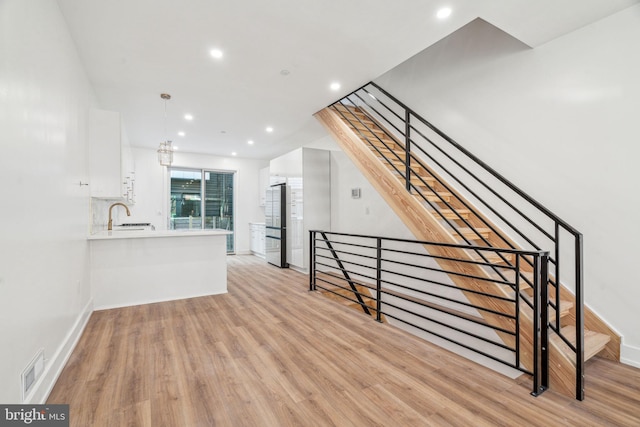 interior space featuring sink and light hardwood / wood-style flooring