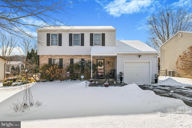 view of front property with a garage, a porch, and central air condition unit