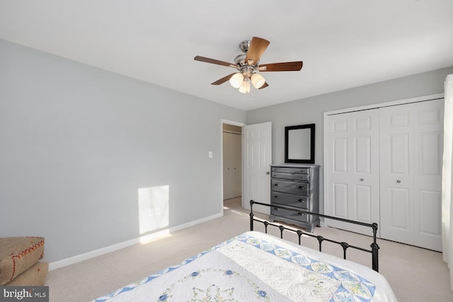 carpeted bedroom with ceiling fan and a closet