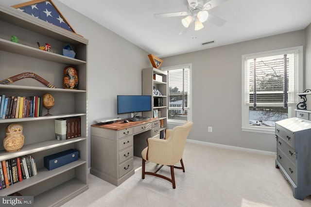 office with light colored carpet and ceiling fan