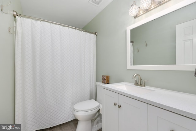 bathroom with vanity, hardwood / wood-style floors, and toilet