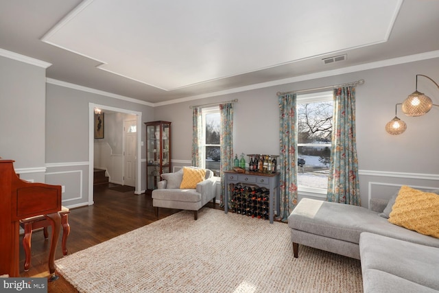 living room featuring crown molding and dark hardwood / wood-style flooring