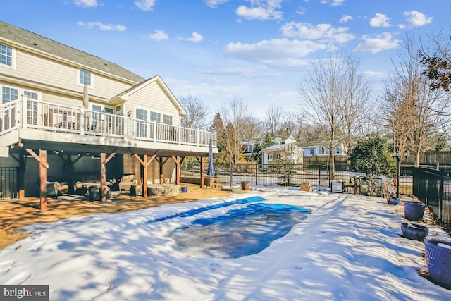 snow covered pool featuring a wooden deck