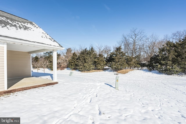 view of yard layered in snow