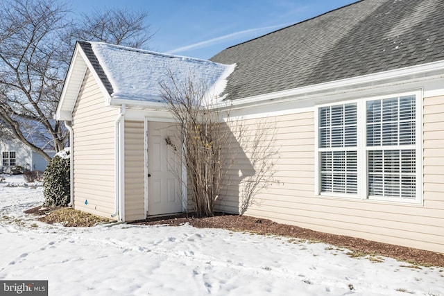 view of snow covered property entrance