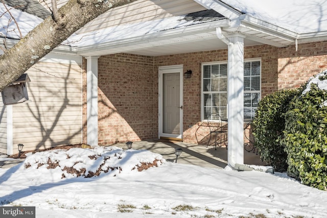 view of snow covered property entrance