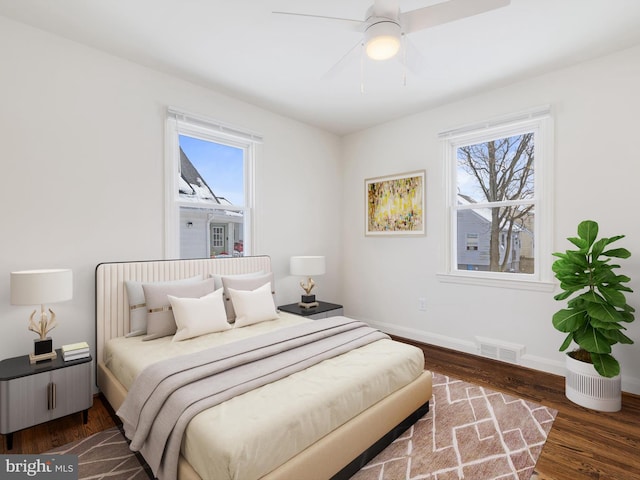 bedroom with ceiling fan and dark hardwood / wood-style flooring