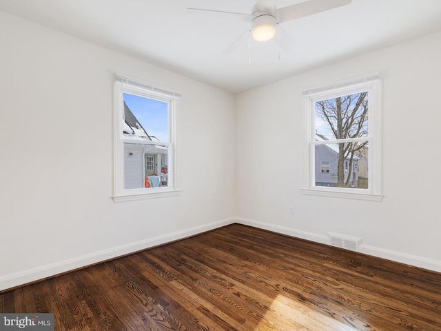 unfurnished room with ceiling fan and dark hardwood / wood-style floors