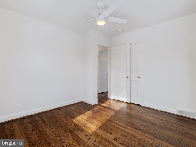 unfurnished bedroom featuring ceiling fan and dark hardwood / wood-style floors