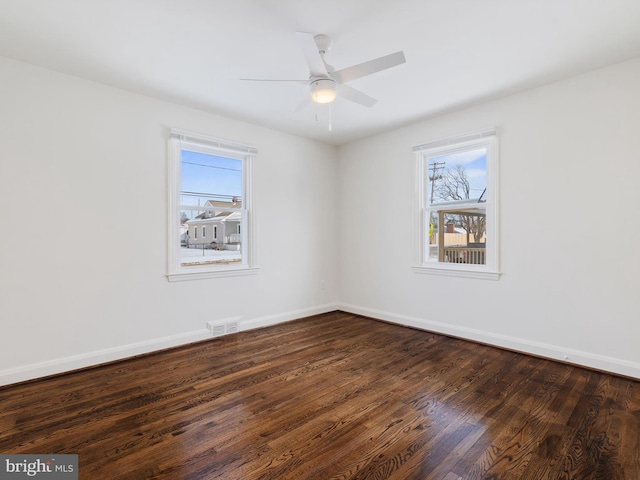 unfurnished room with ceiling fan, dark hardwood / wood-style flooring, and a healthy amount of sunlight